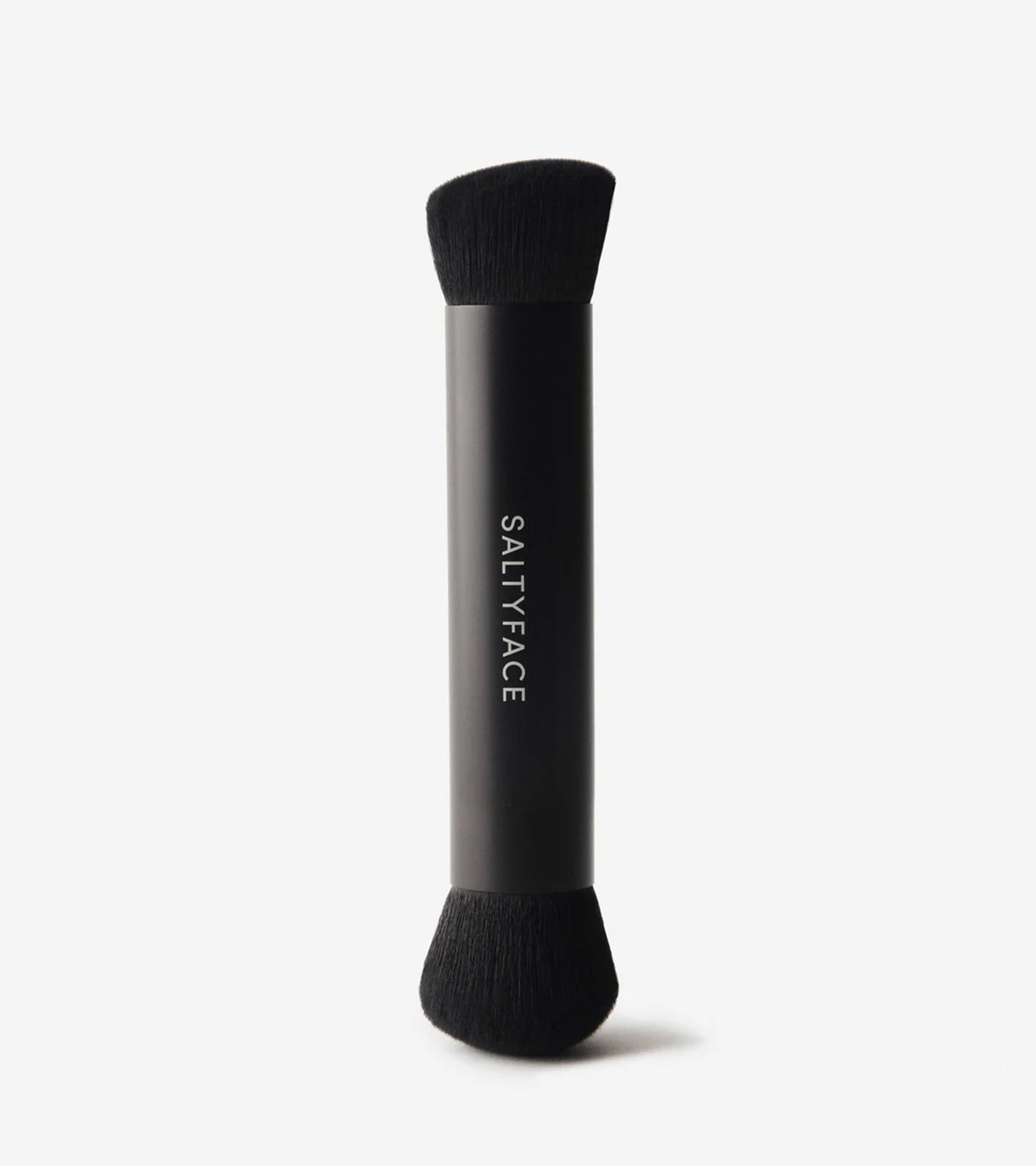Brush No. 3 is a double-ended brush with black bristles and a sleek black handle featuring SALTYFACE printed vertically in white, designed for seamless Liquid Bronzer application and shown against a plain white background.