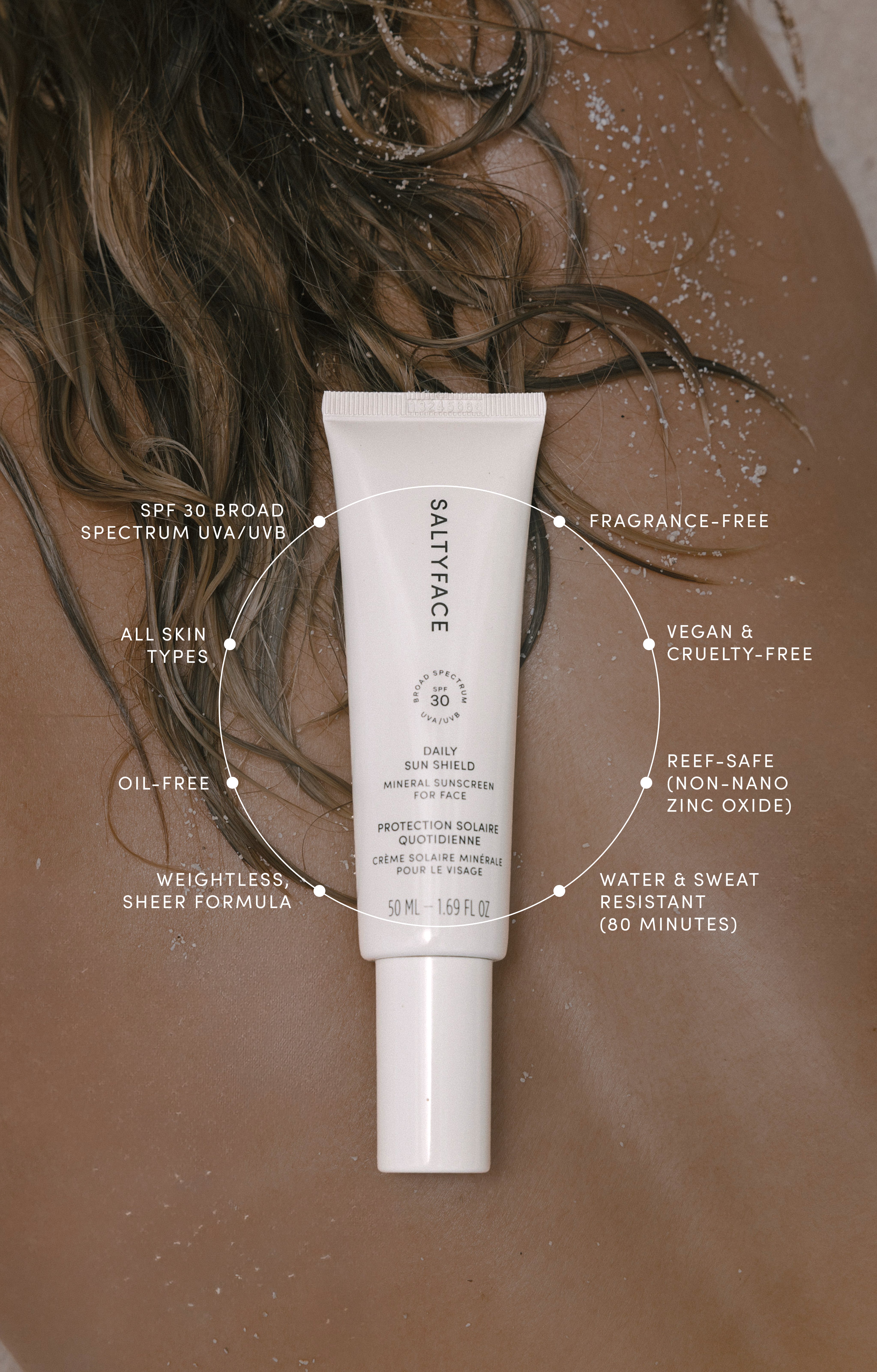 A tube of Daily Sun Shield sits on someones wet, sun-kissed back, featuring SPF 30 protection, reef-safe mineral formula, water resistance, fragrance-free and vegan attributes noted in surrounding text.