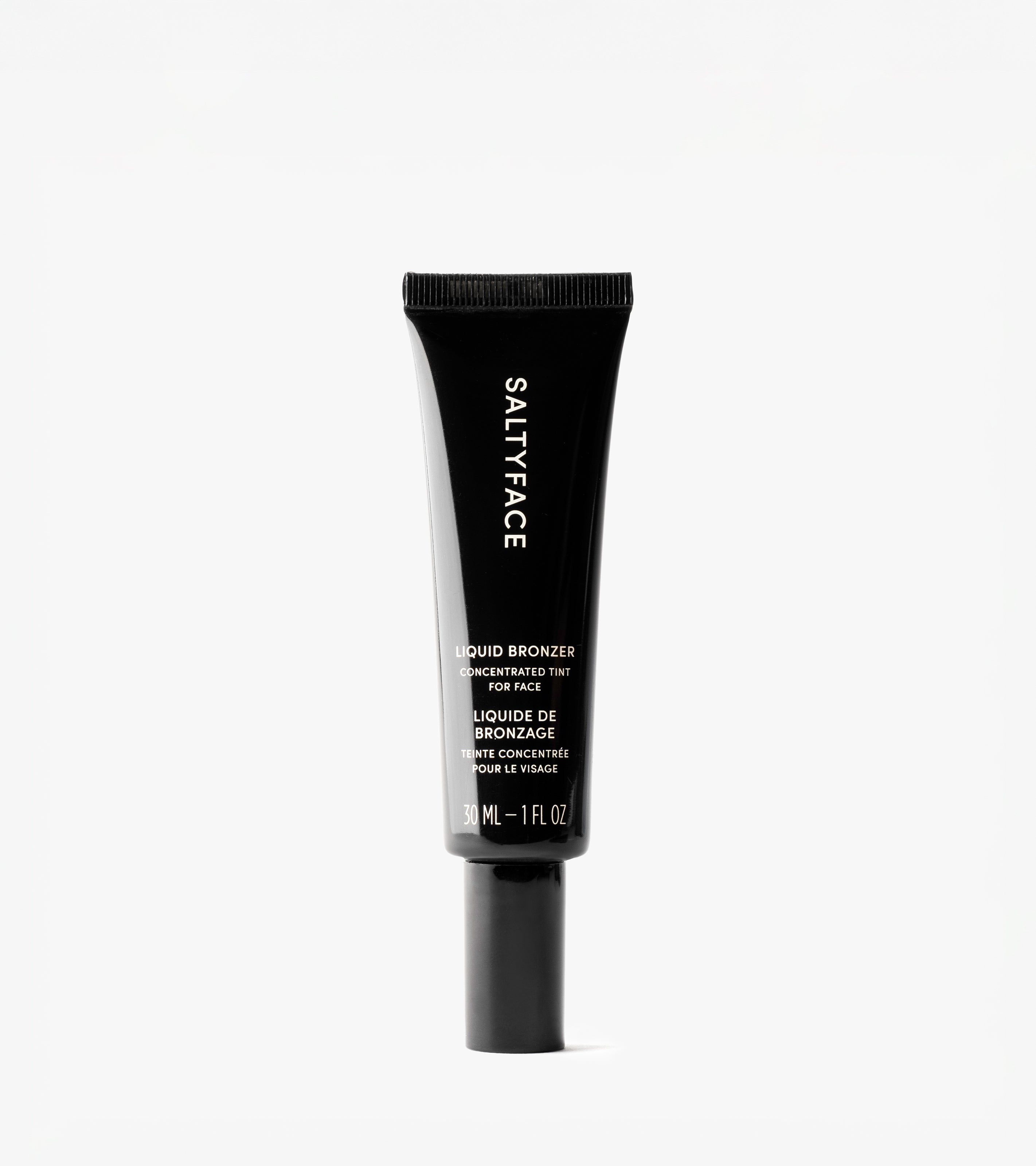 A black tube of Liquid Bronzer stands upright against a plain white background, with the product name displayed in English and French on the packaging.
