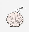 A pale pink, shell-shaped Air Freshener with a black outline and string. "SALTYFACE" is printed near the bottom center, making it perfect for gifts or coastal-themed décor.