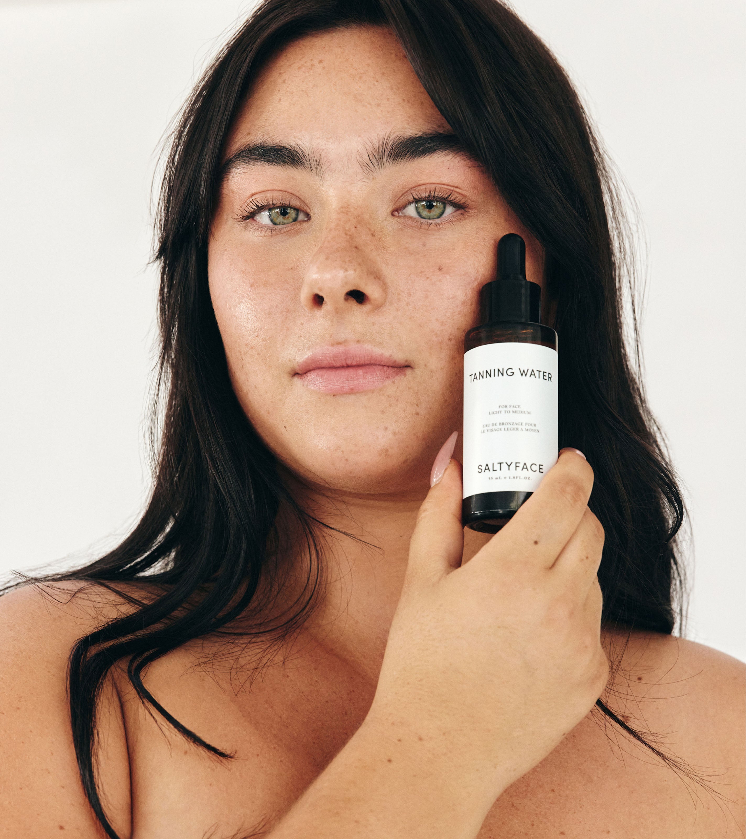 Model holding Saltyface Tanning Water