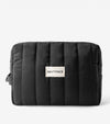 The Everywhere Bag—a black, quilted zip pouch with vertical stitching and a white SALTYFACE label—sits on a plain white background, ideal as an essentials organizer for daily use or travel.