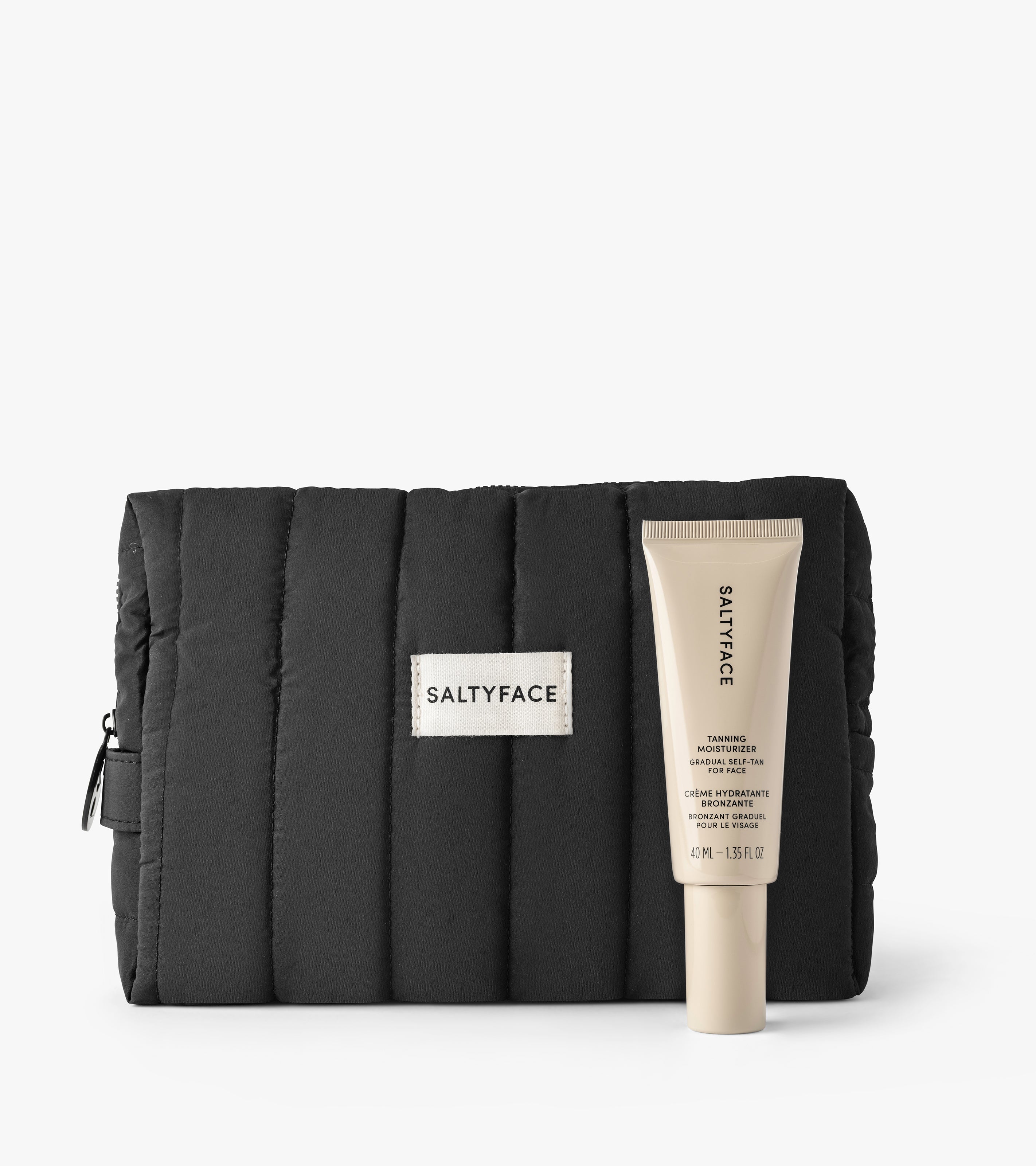 The Holiday Duo features a black quilted pouch and a beige SALTYFACE Tanning Water Moisturizer tube, displayed on a white background.