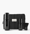 The Holiday Essential Set features black Saltyface skincare—including tanning foam, tanning water, a brush, and a padded pouch—arranged neatly against a white background.