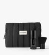 The Holiday Face Set includes a black quilted SALTYFACE cosmetic bag, a black bottle of SALTYFACE Tanning Water, and a small black makeup brush.