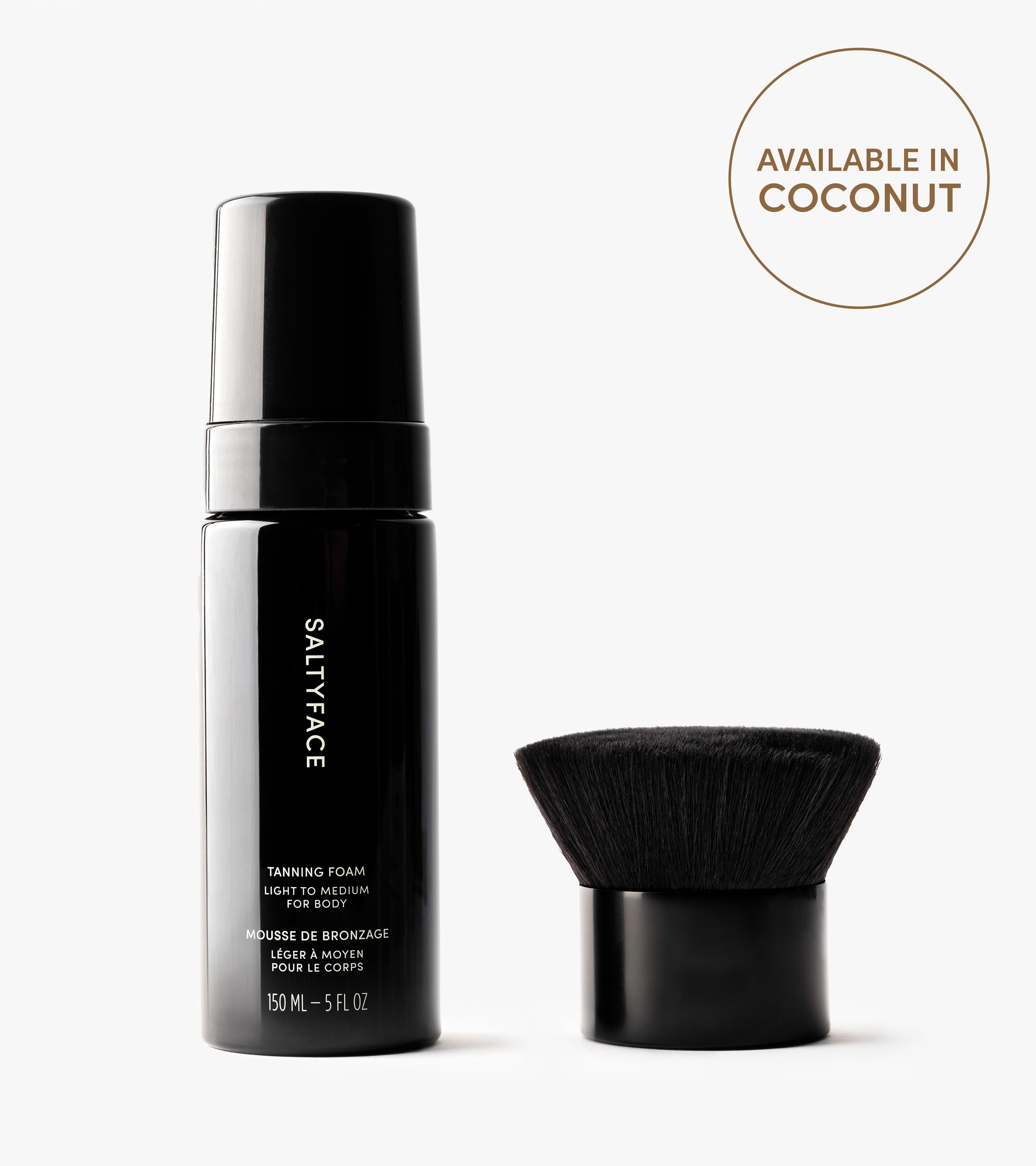 A black bottle labeled The Body Set stands next to a sleek body brush. Above them, a circle says Available in Coconut on a white background, ready to give you a flawless sun-kissed tan.