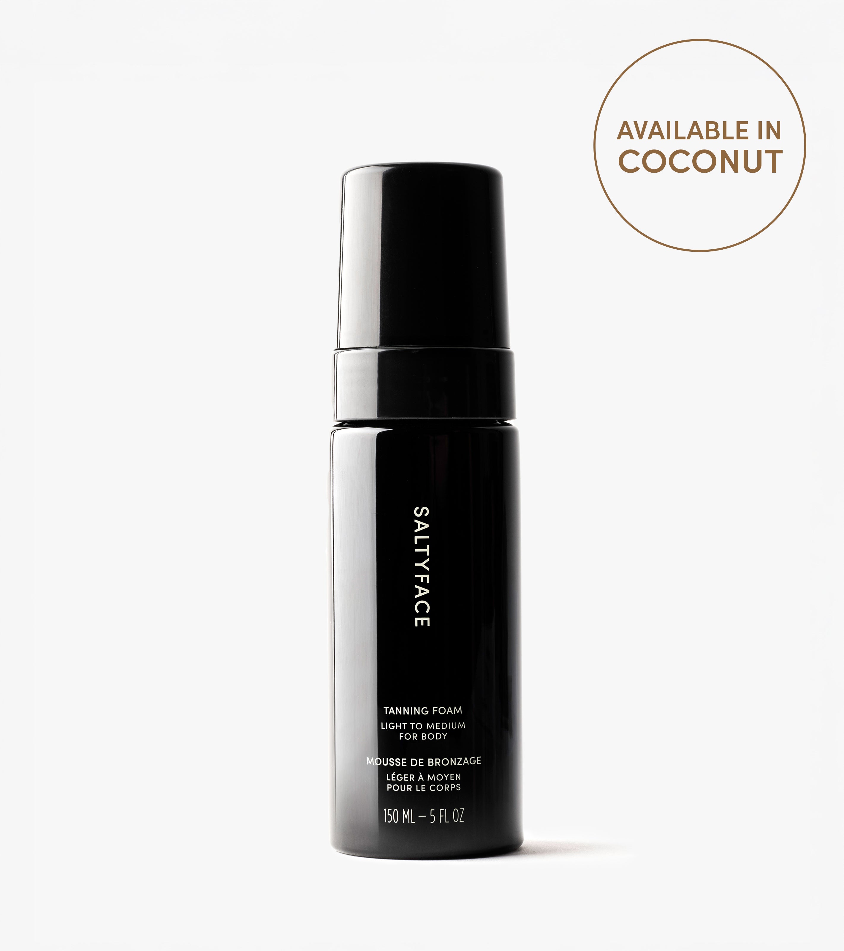 A black bottle of Tanning Foam (Light to Medium) is shown on a white background, offering a coconut scent and water-to-foam formula for easy self tanning. This body care product comes in a 150 mL (5 fl oz) size.