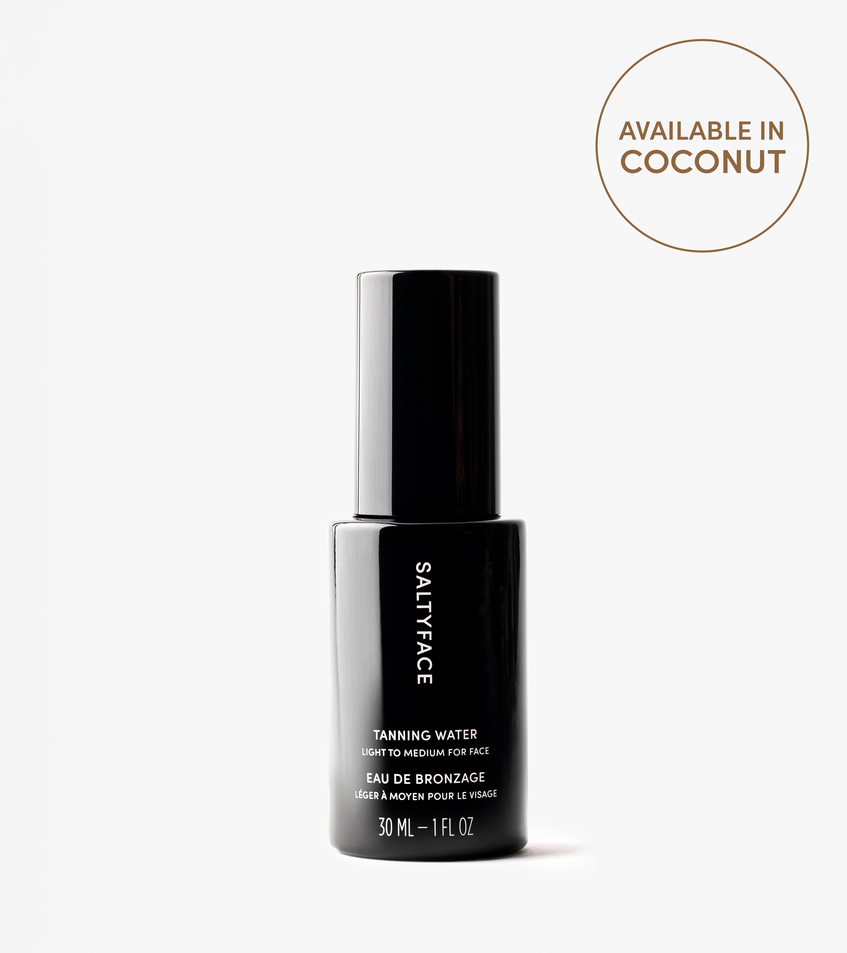 A black bottle labeled Tanning Water, Light to Medium for Face, 30 ml stands upright on a white background. Achieve an award-winning sun-kissed tan. A nearby circle reads: Available in Coconut.