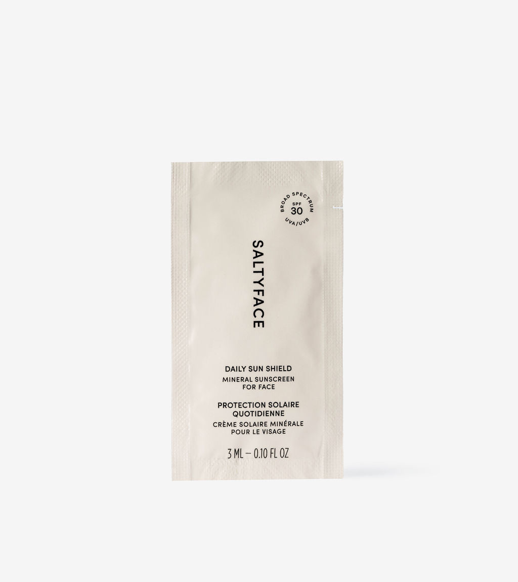 A small sachet labeled Daily Sun Shield Sample, containing 3 mL (0.10 fl oz) of SPF 30 mineral sunscreen, is shown against a plain white background.