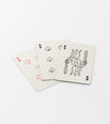 Three Playing Cards fanned out on a white surface: the 5 of hearts, 6 of spades, and king of spades, each featuring a black and white illustrated design.